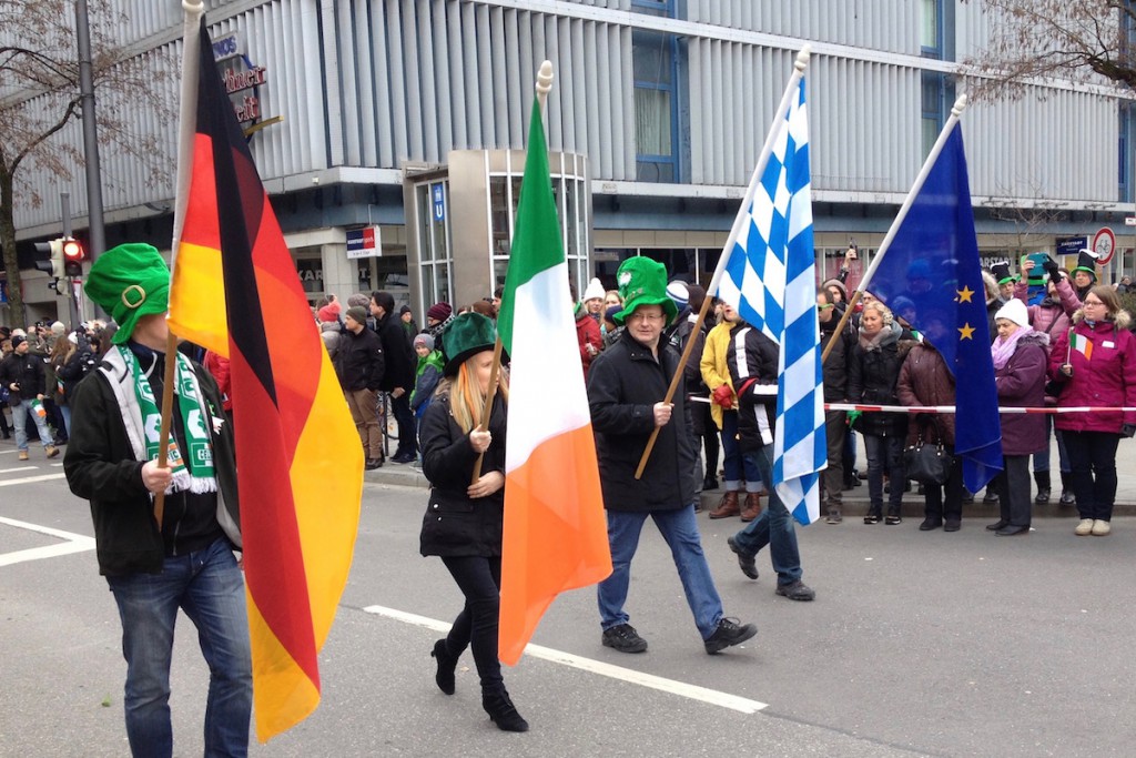 The flags of Germany, Ireland, Bavaria and Europe are carried by four people at the head of the parade.